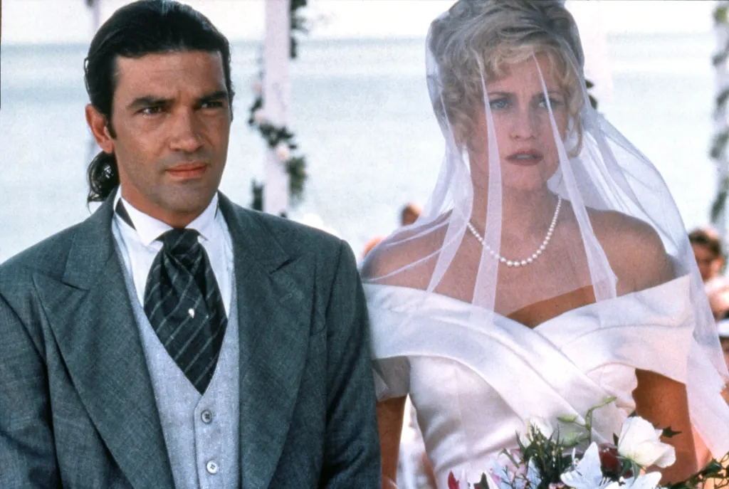 Antonio Banderas in a suit and Melanie Griffith in a wedding dress and veil.