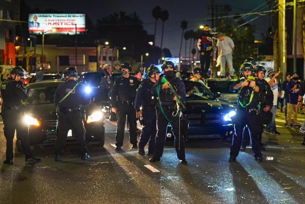 Los Angeles Police officers order fans to disperse on Sunset Boulevard in Los Angeles after the Dodgers won the World Series.