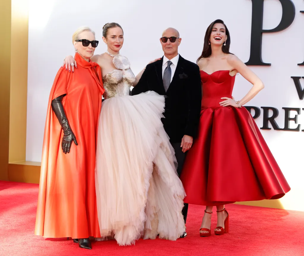 Meryl Streep, Emily Blunt, Stanley Tucci, and Anne Hathaway pose on a red carpet.