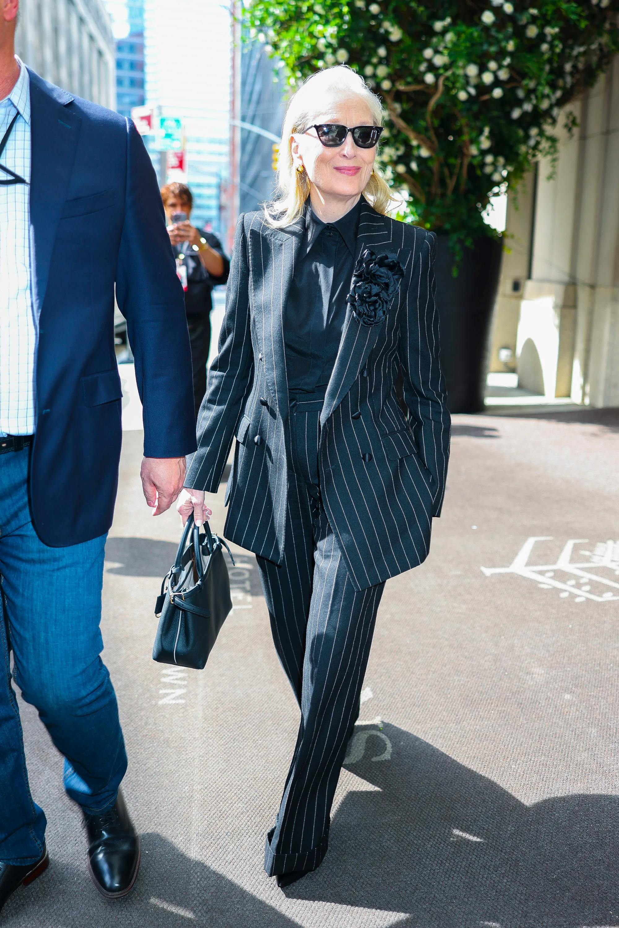 Meryl Streep wearing a pinstripe pantsuit in New York City.