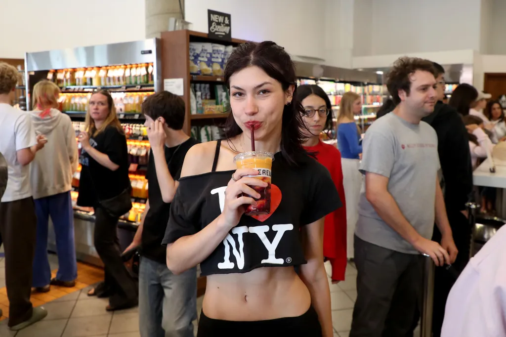 Angelina Gault sips a drink at Erewhon in Beverly Grove.