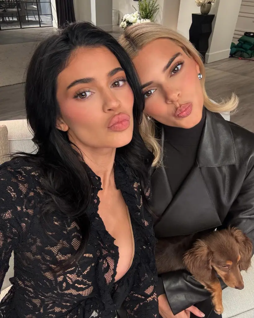 Kylie Jenner and Kendall Jenner taking a selfie with a dog.