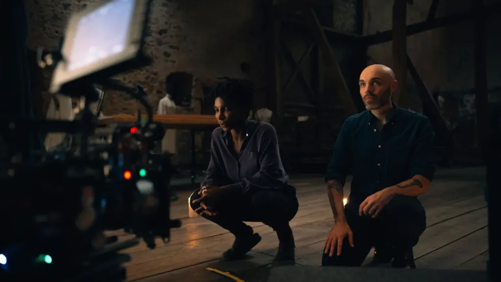 Michaela Coel and David Lowery on the set of 