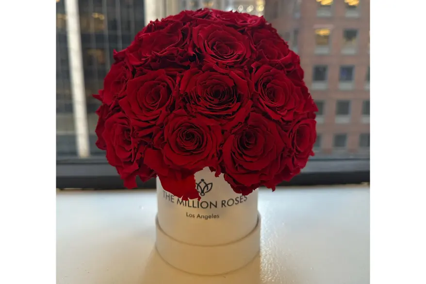 A bouquet of red roses in a white box from The Million Roses.