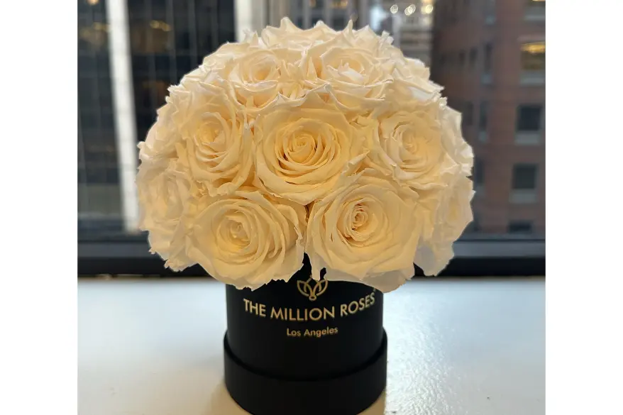 A bouquet of white roses in a black box from The Million Roses.