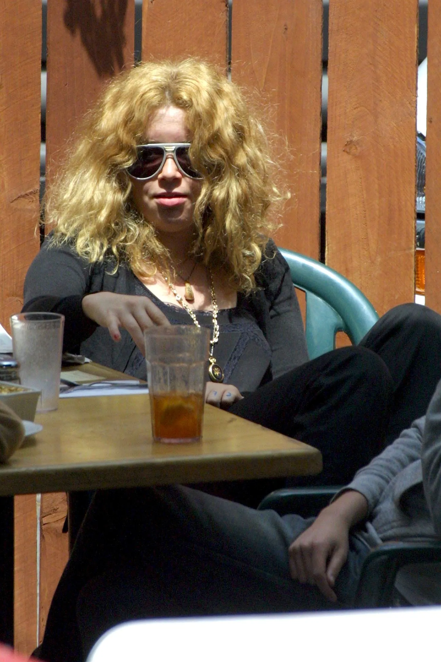 Natasha Lyonne eating lunch outdoors.