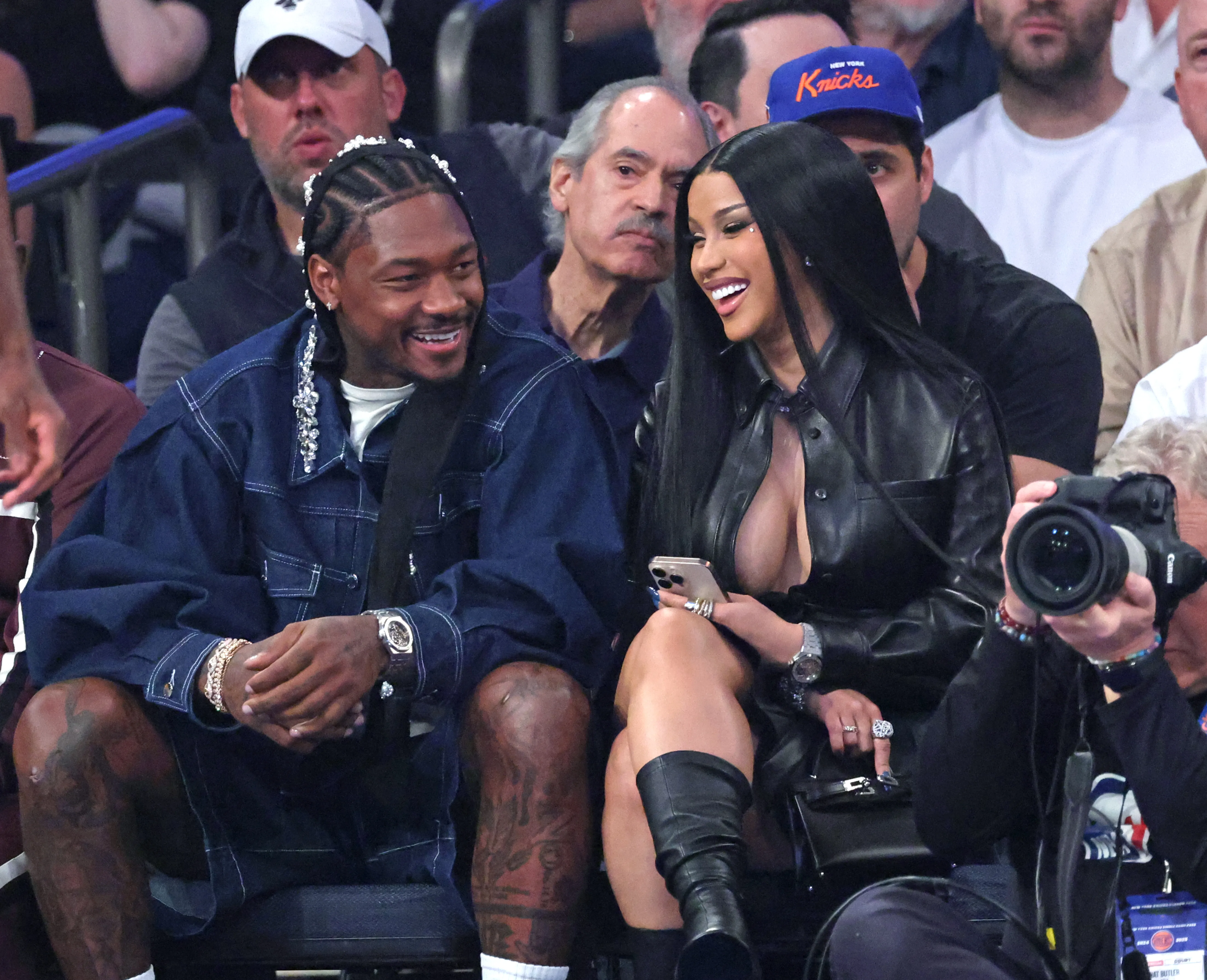 Rapper Cardi B and NFL player Stefon Diggs sitting courtside during an NBA Playoffs game.