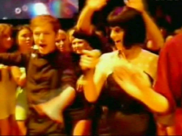 Katy Perry and Ruby Rose dancing with students at a school prom.