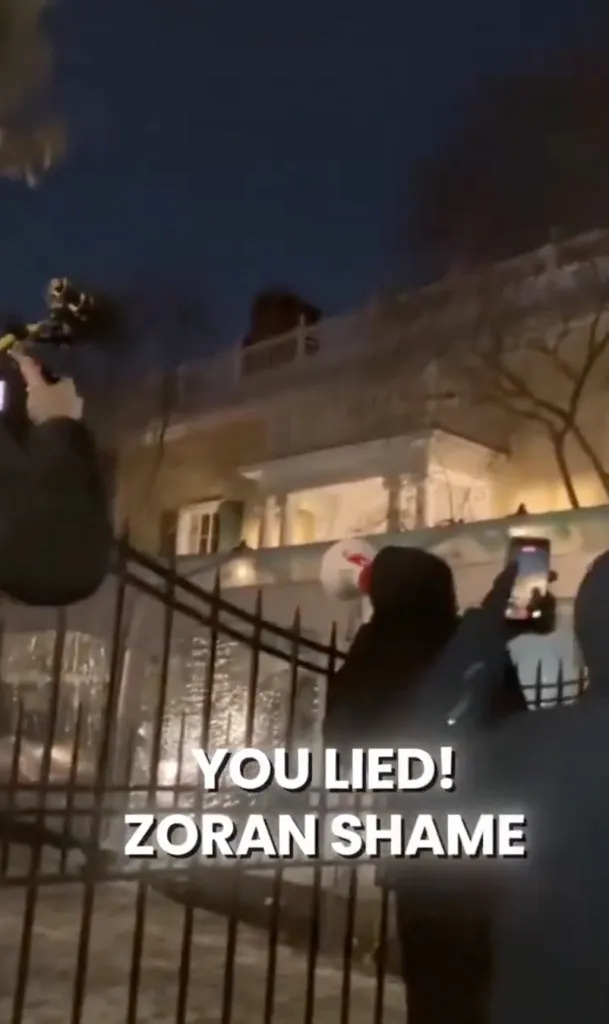 People protesting in front of Gracie Mansion