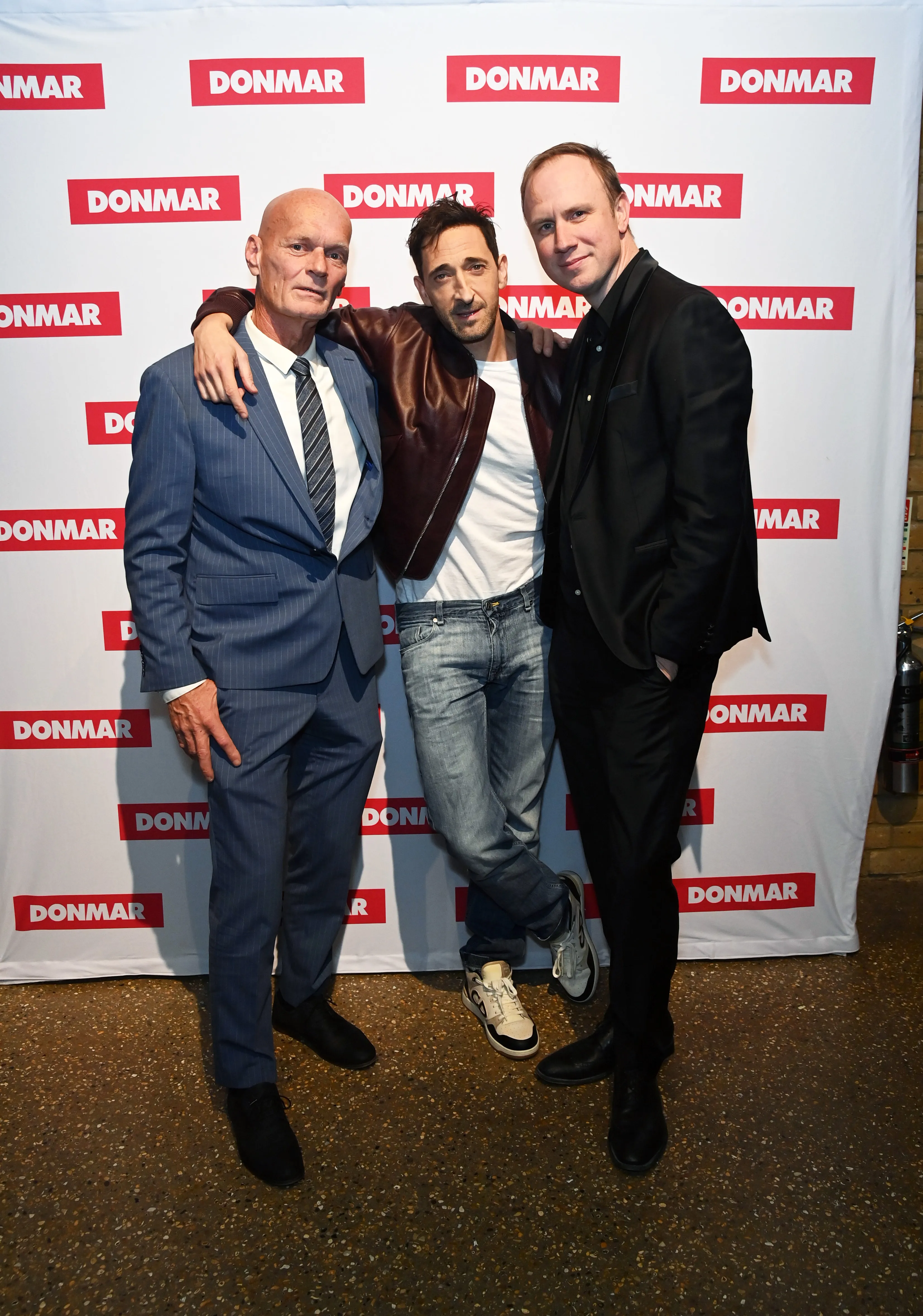 Nick Yarris, Adrien Brody, and Justin Martin standing together at "The Fear Of 13" press night after party.