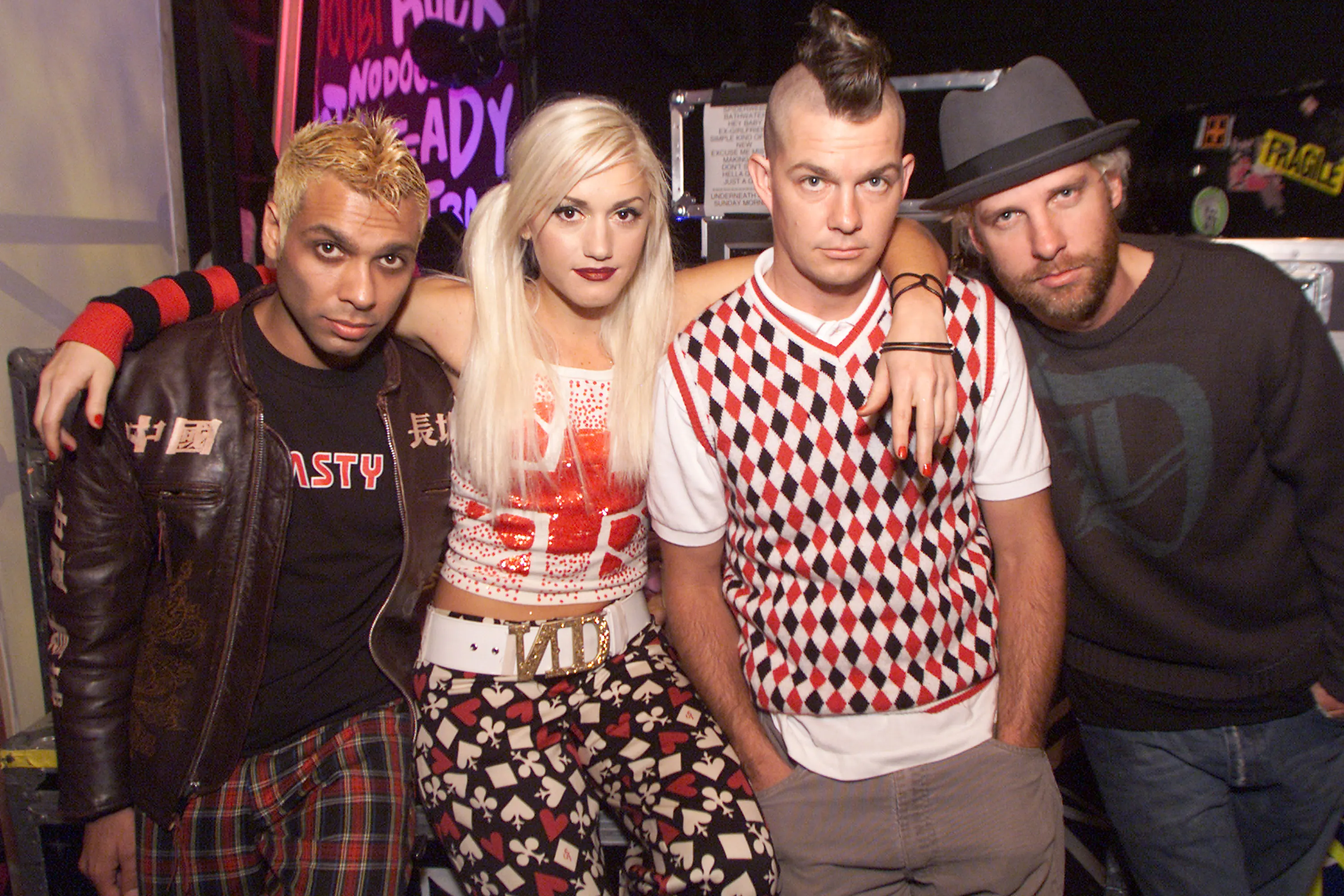 No Doubt band members Tony Kanal, Gwen Stefani, Adrian Young, and Tom Dumont pose together backstage.