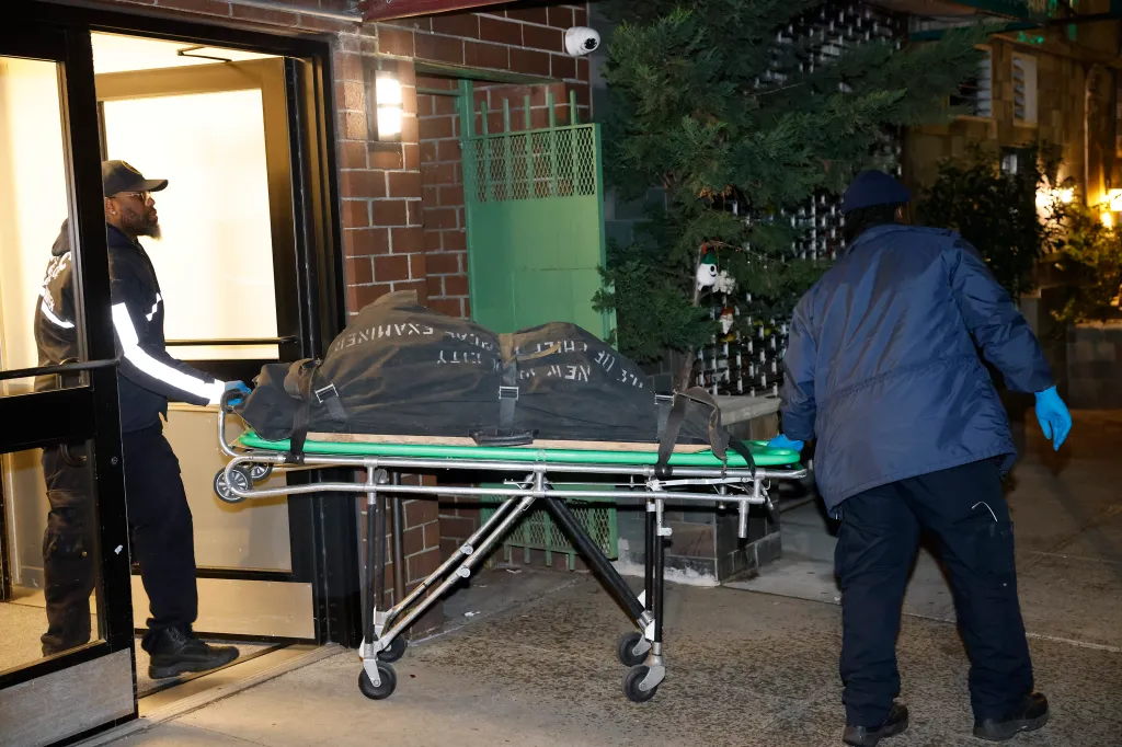 Medical examiners remove a body from a New York City apartment building.