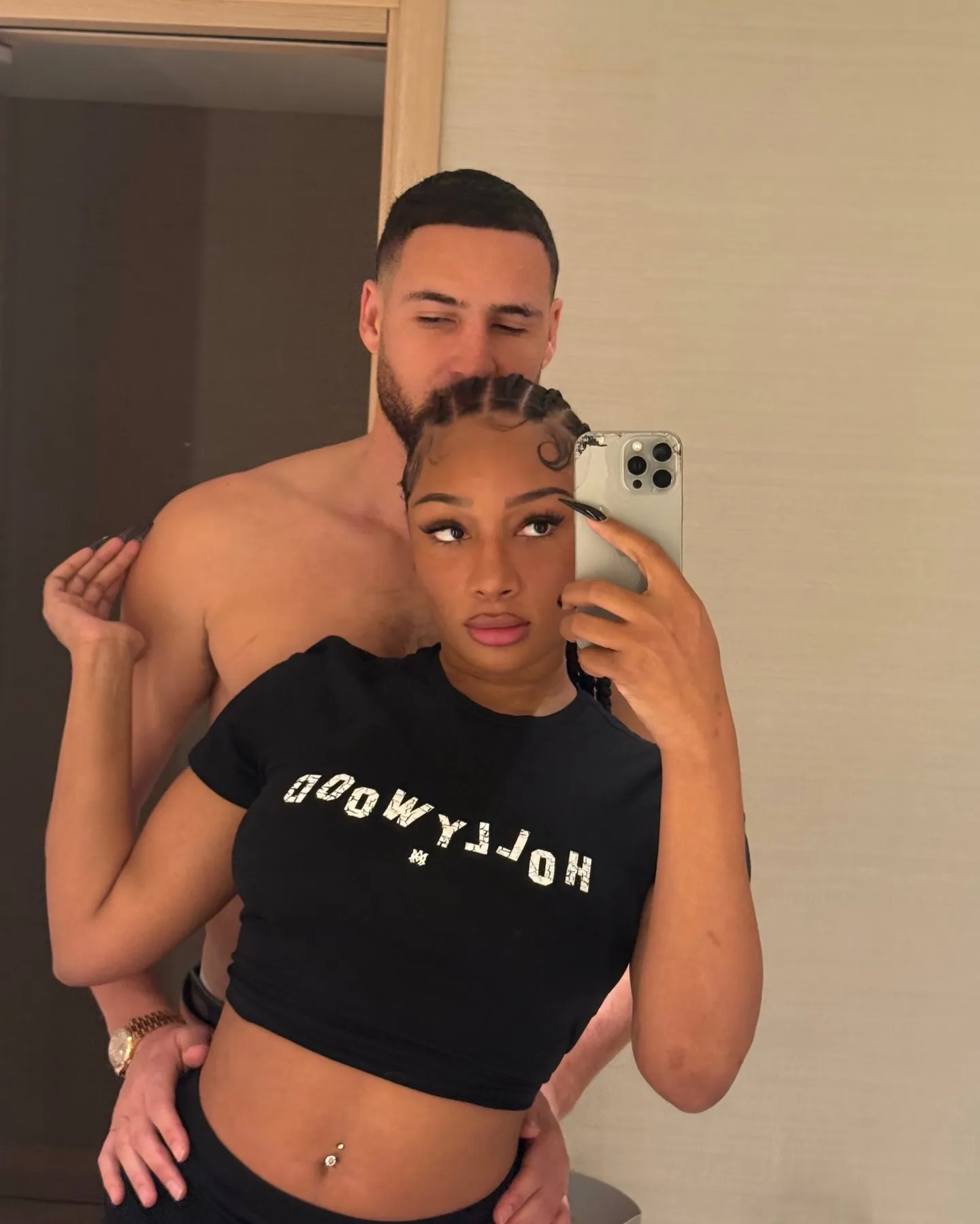 Klay Thompson embracing Megan Thee Stallion while she takes a mirror selfie.