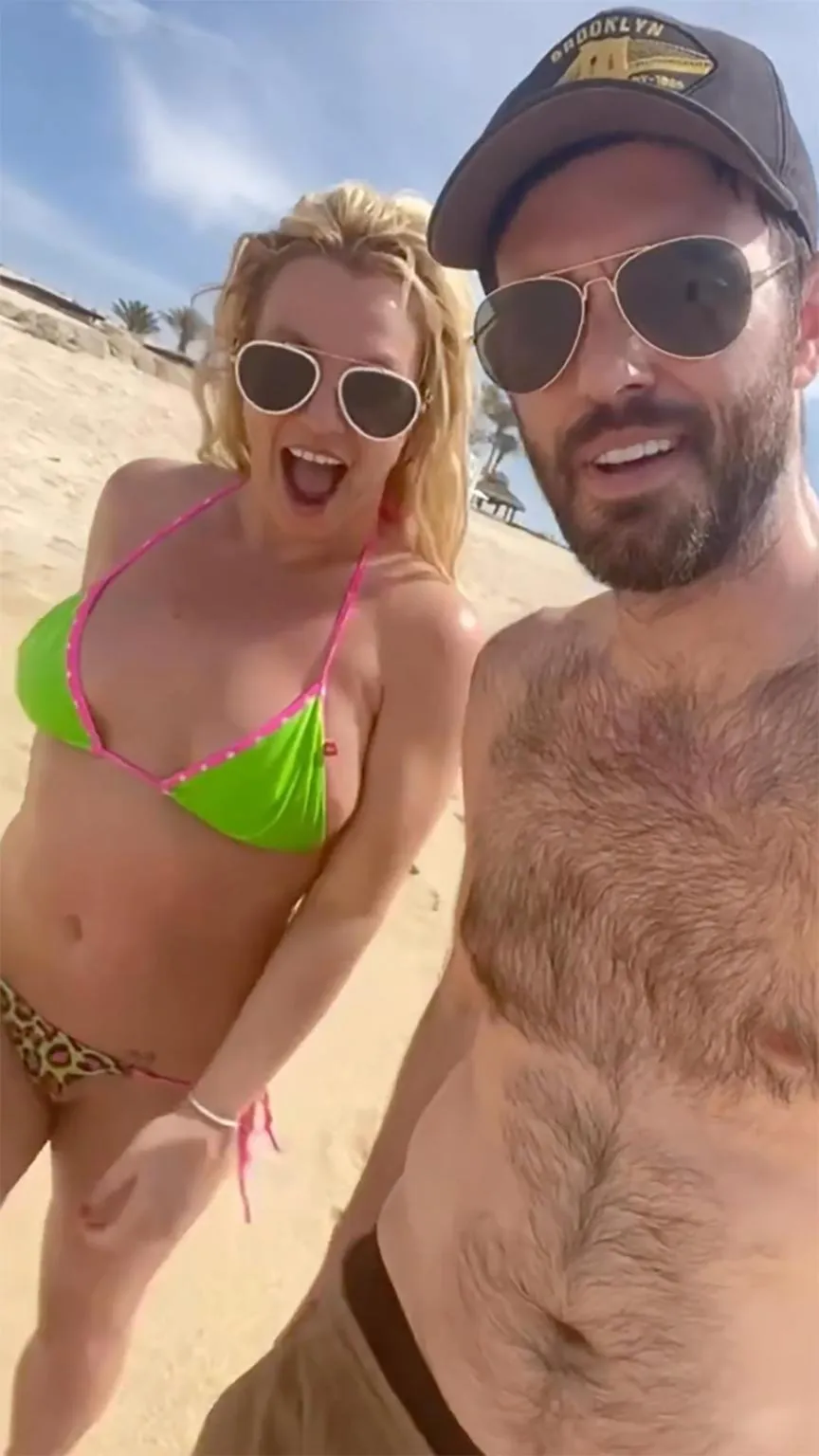 Britney Spears and Cade Hudson on a beach.