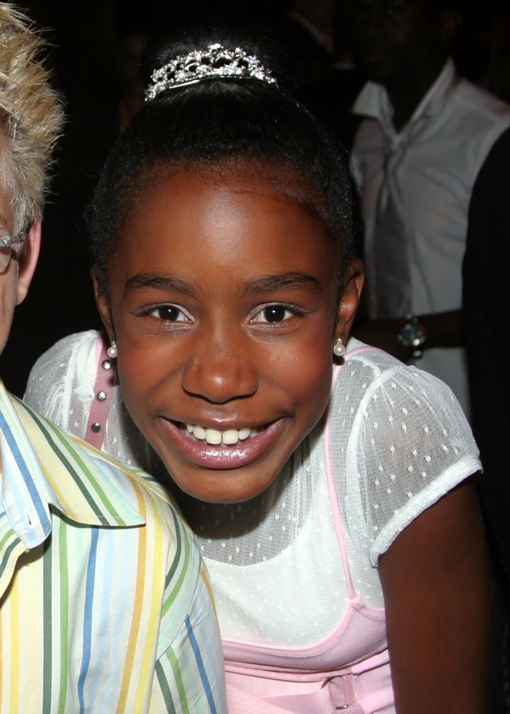 Kianna Underwood smiling, wearing a tiara and pearl earrings, next to Jonathan Lipnicki.