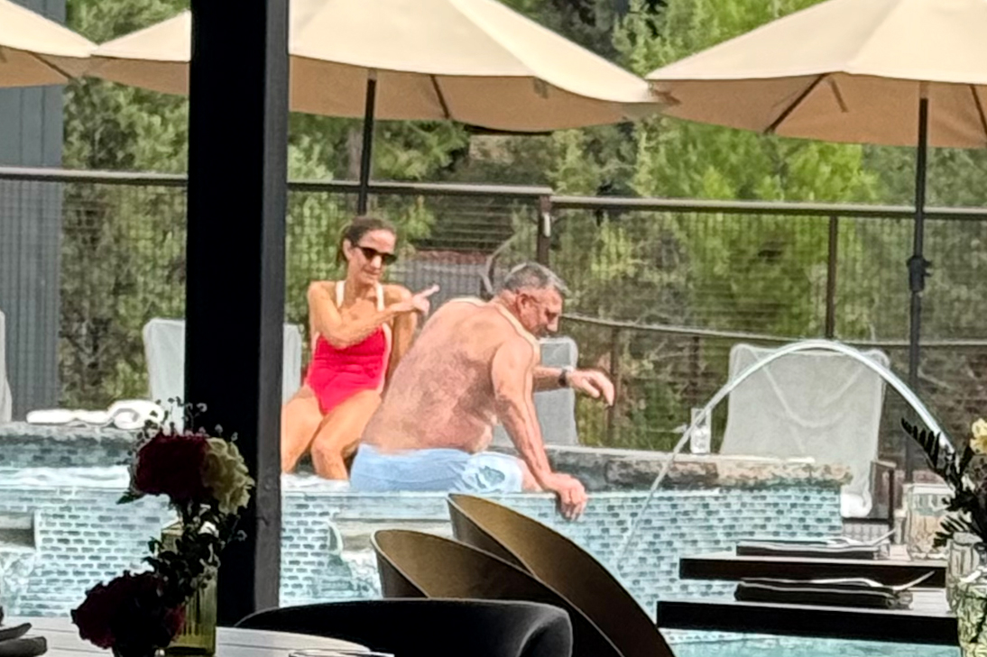 Dianna Russini and Mike Vrabel lounging poolside.