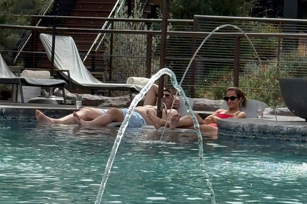 Mike Vrabel and Dianna Russini relaxing by a hotel pool.