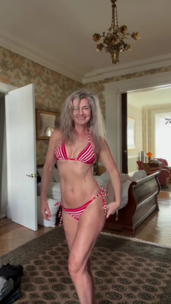 Paulina Porizkova in a red and white striped bikini.