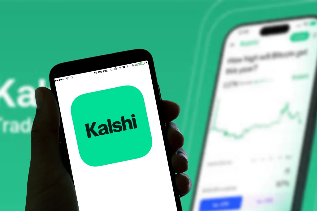 Photo illustration of a smartphone displaying the Kalshi online betting app logo.