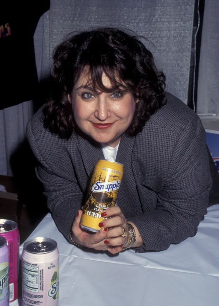 Wendy Kaufman holding a can of Snapple Lemon Flavored Iced Tea.