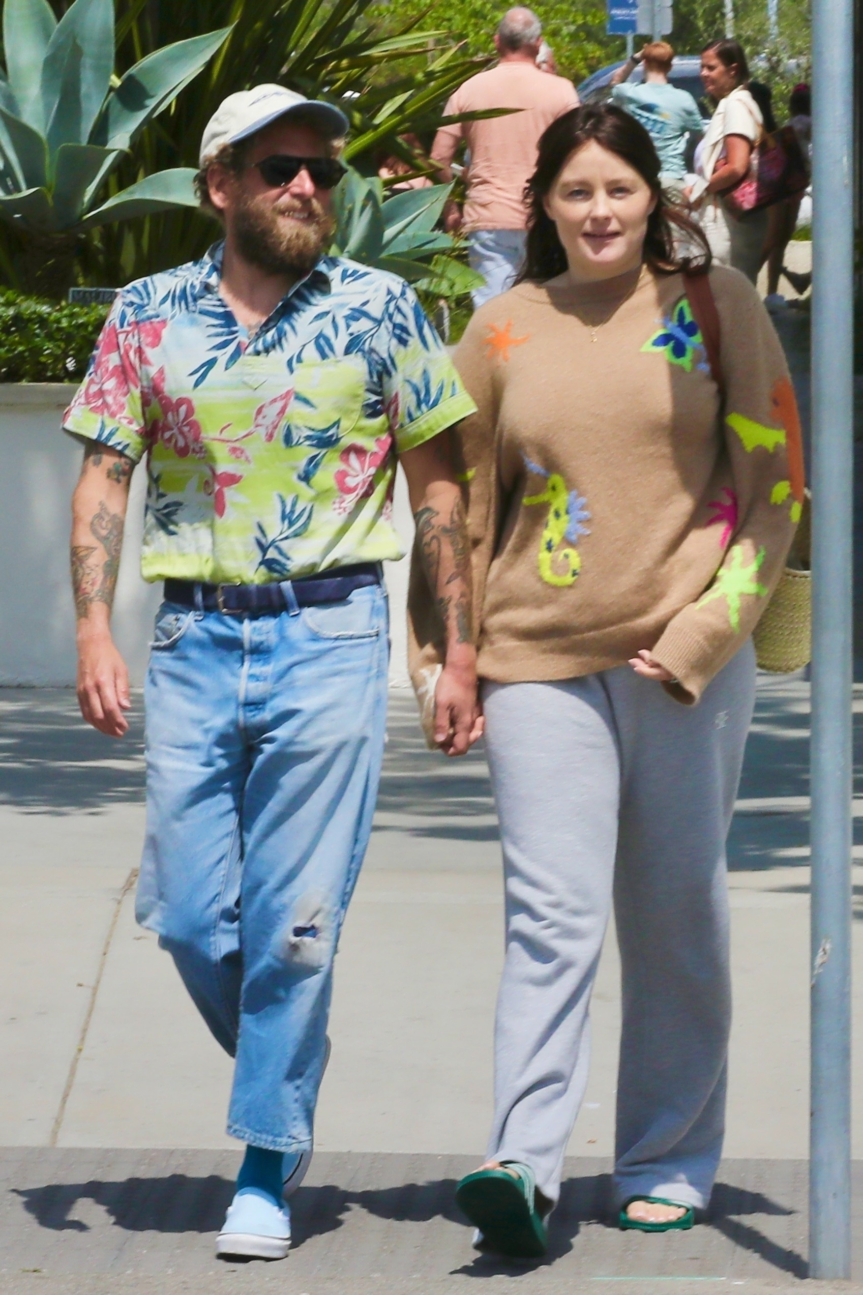Jonah Hill and Olivia Millar holding hands while walking in Malibu.