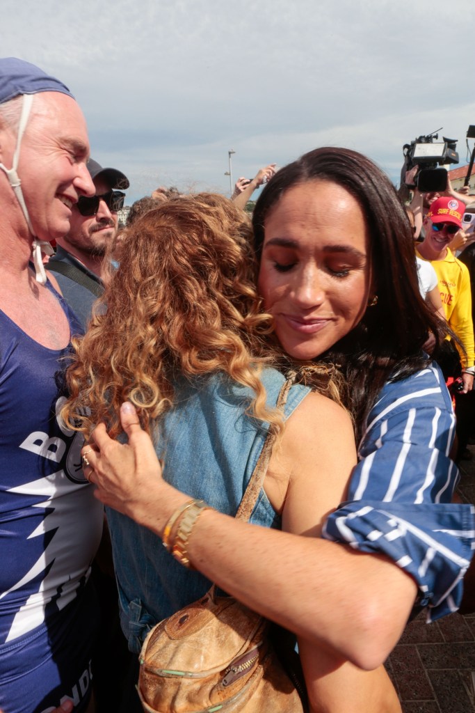 Meghan Markle hugging a fan at Bondi Beach.