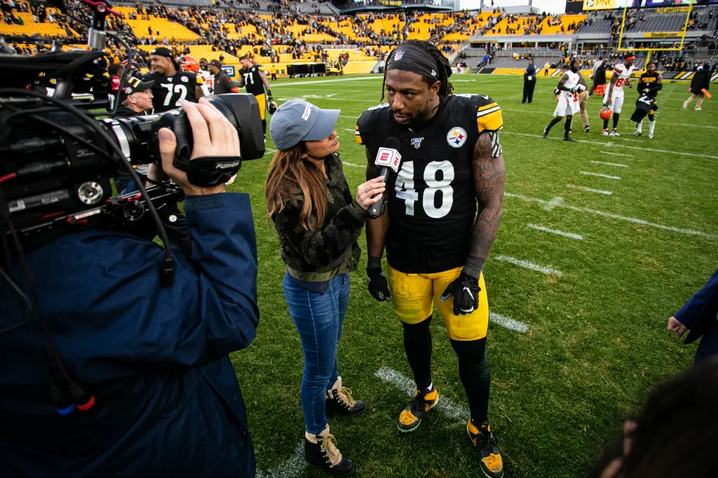 Dianna Russini interviews Bud Dupree on a football field.