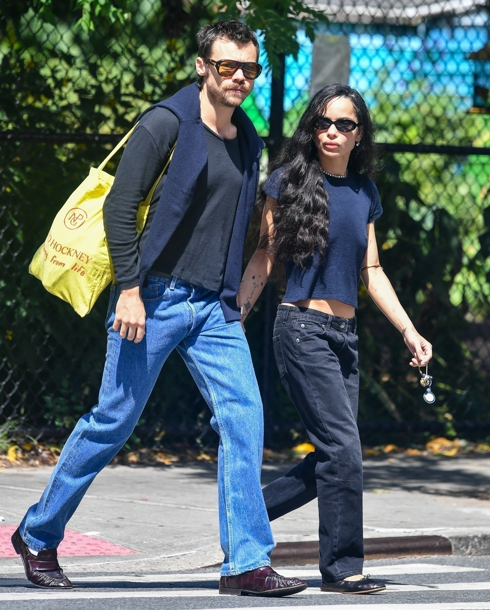 Harry Styles and Zoe Kravitz walking hand-in-hand.