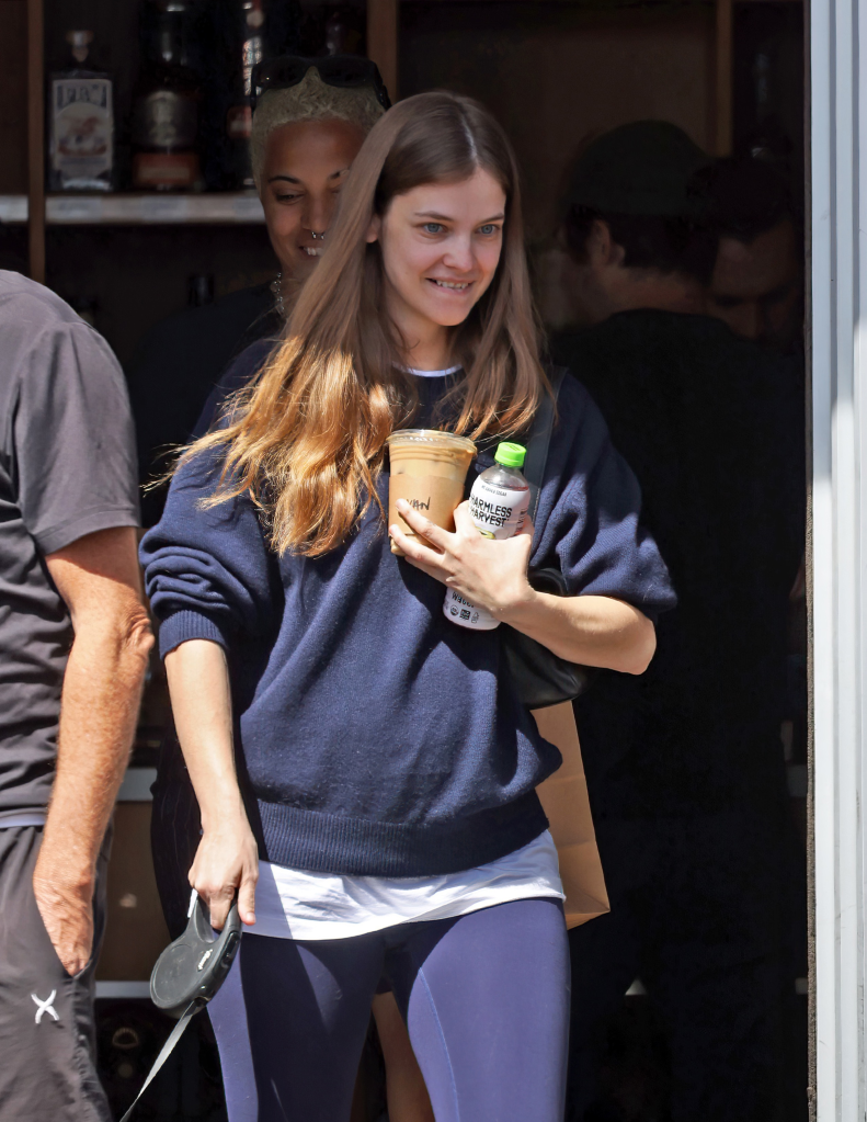 Barbara Palvin holding a cold coffee and a bottle of Harmless Harvest in Los Angeles.