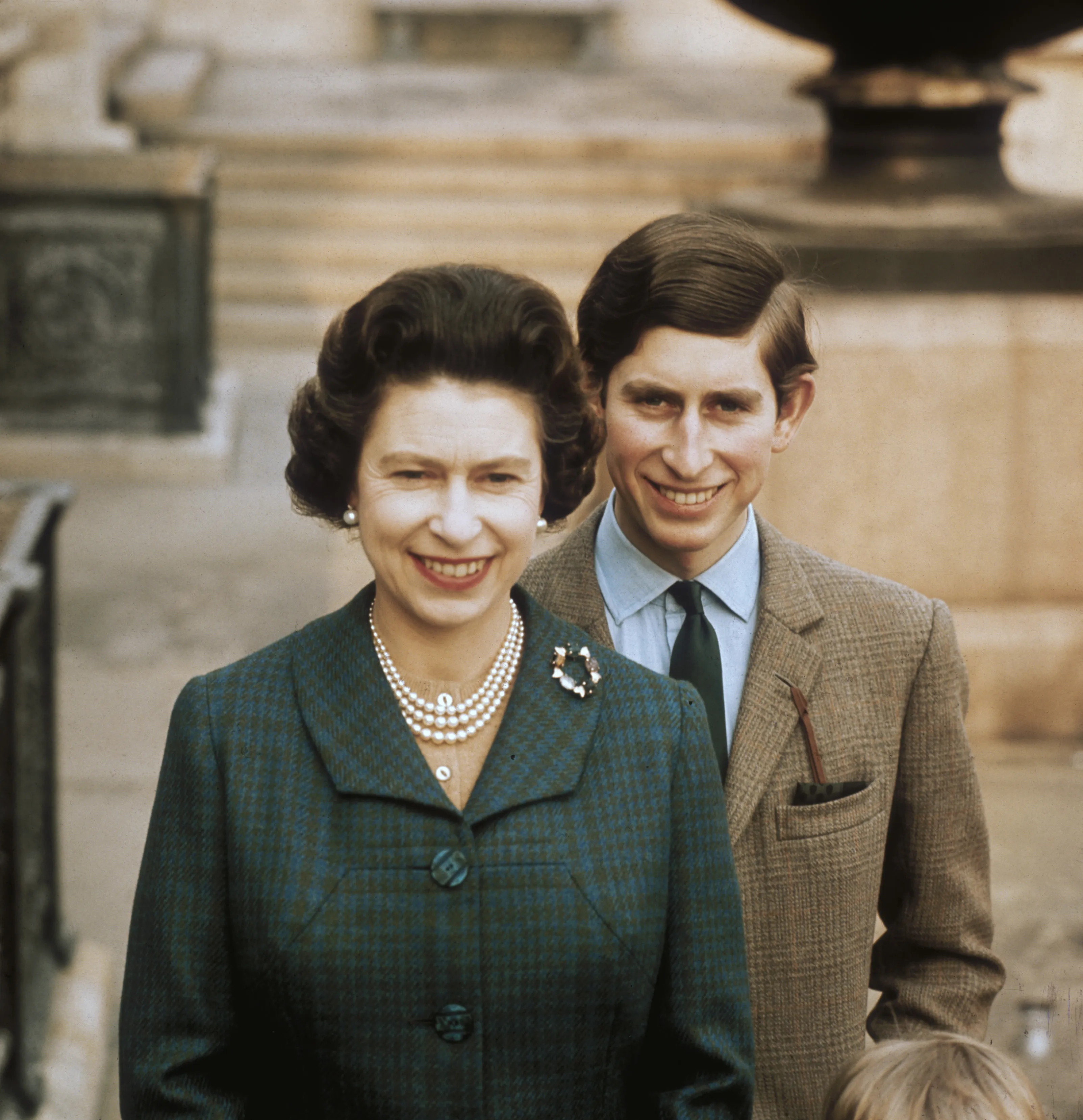 Queen Elizabeth II and Prince Charles smiling.