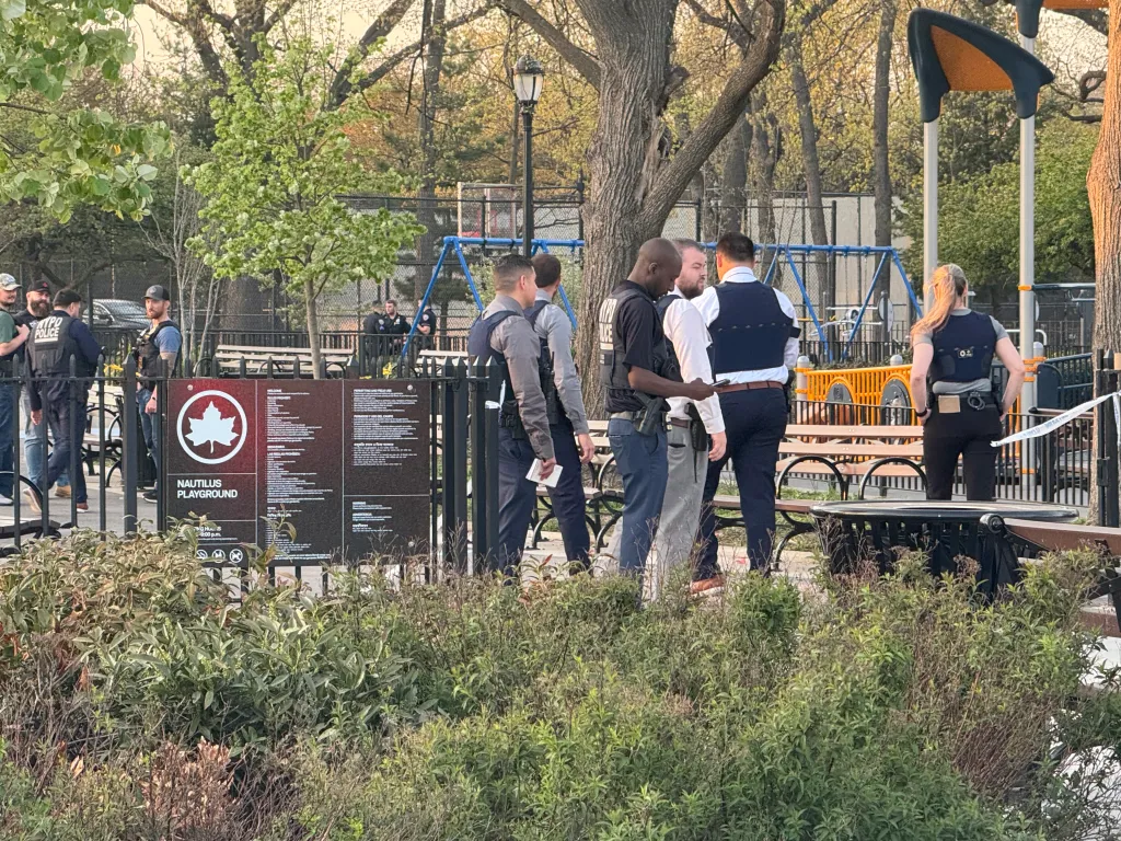Police officers and detectives investigating a shooting at Nautilus Playground in Queens.