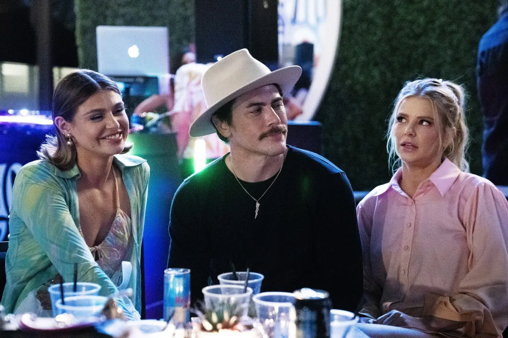 From left to right, Raquel Leviss, Tom Sandoval, and Ariana Madix seated at a table.
