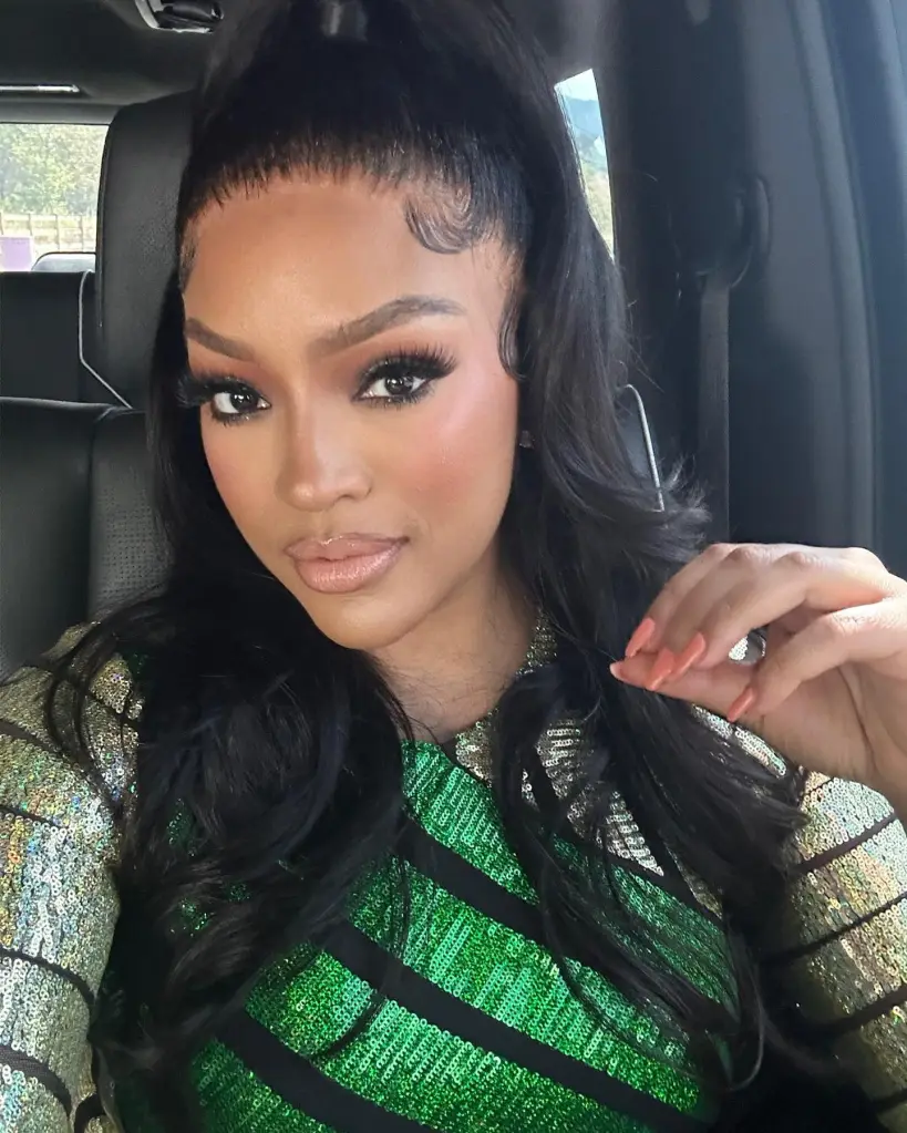 Drew Sidora in a car, wearing a green sequined top, with her hair styled in a high ponytail.