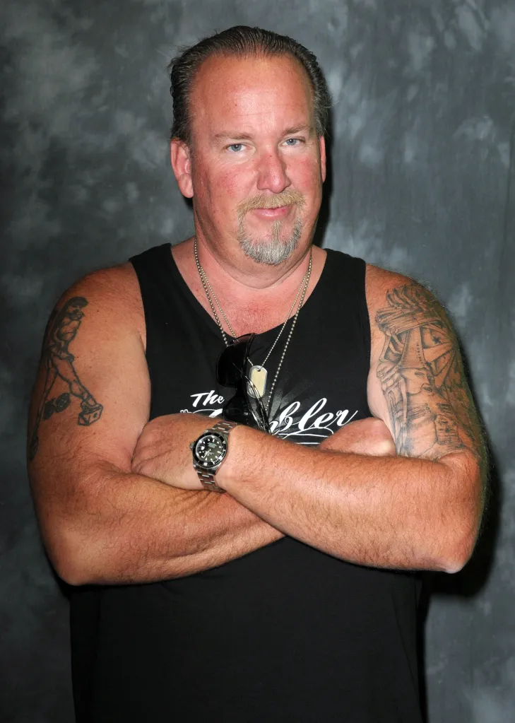 Darrell Sheets with folded arms and tattoos on each arm.