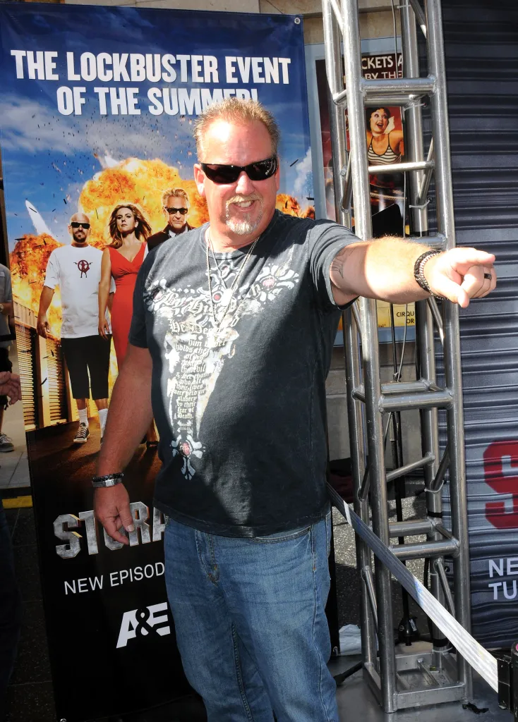 Darrell Sheets from *Storage Wars* in front of a promotional banner for the show.