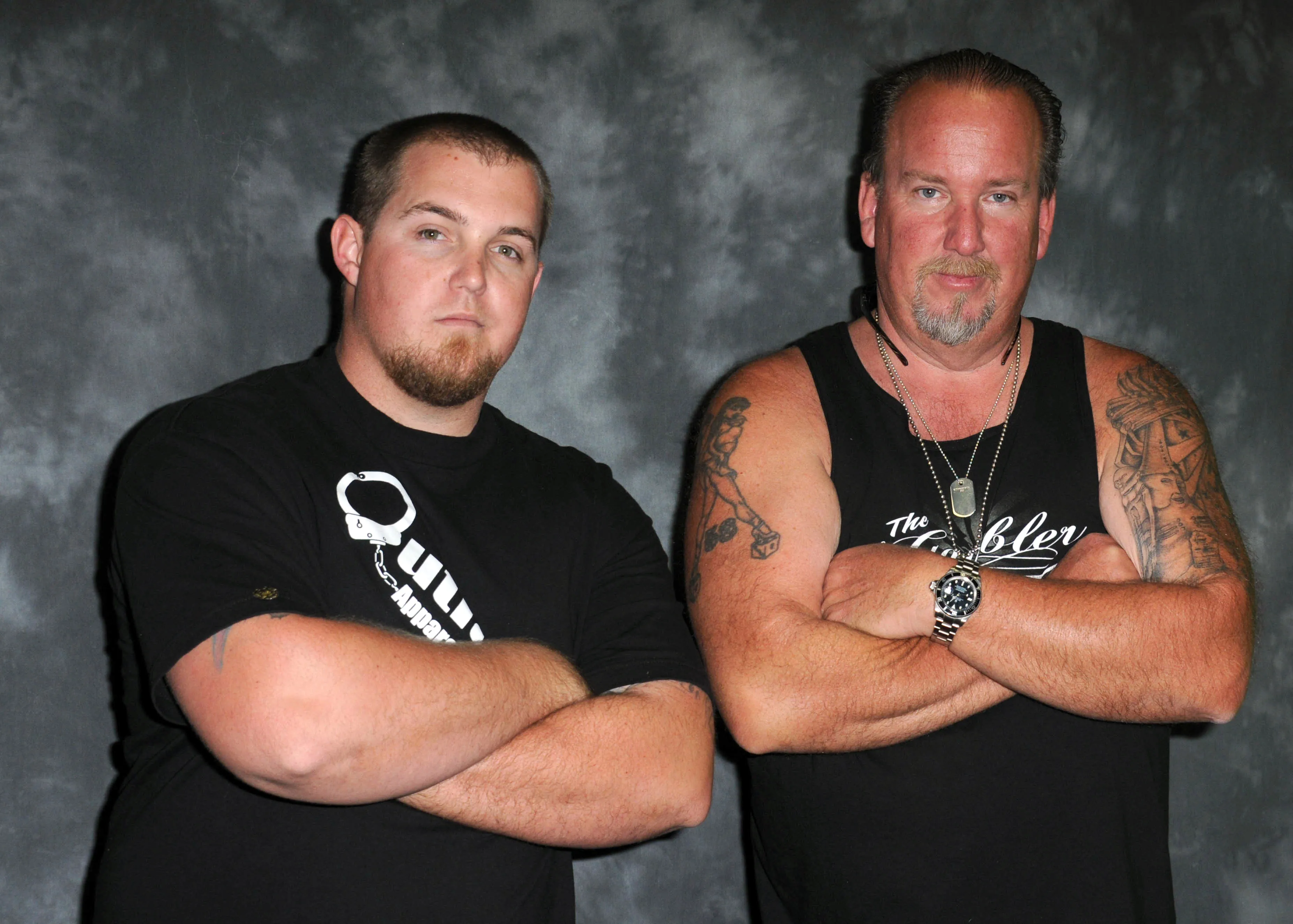 Brandon Sheets and Darrell Sheets posing with their arms crossed.