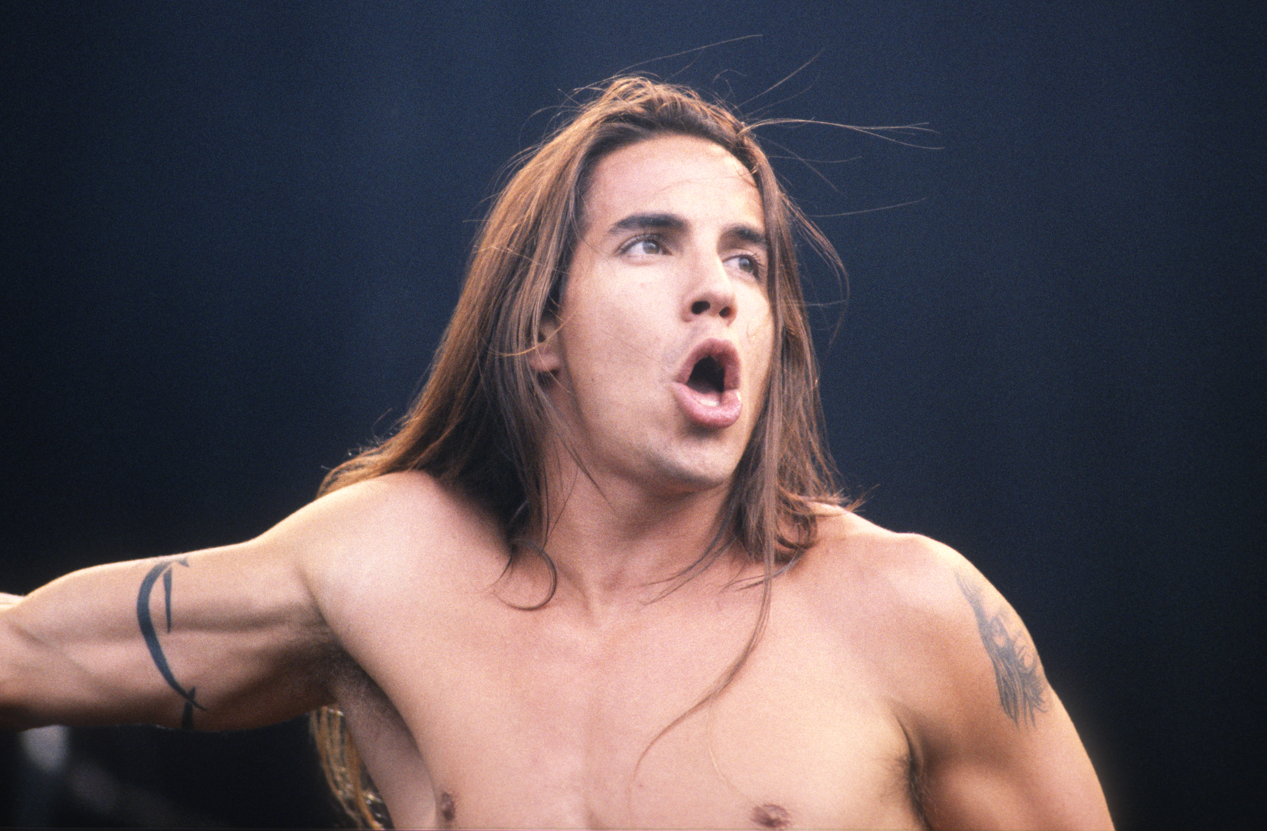 Anthony Kiedis performing at a Red Hot Chili Peppers concert.