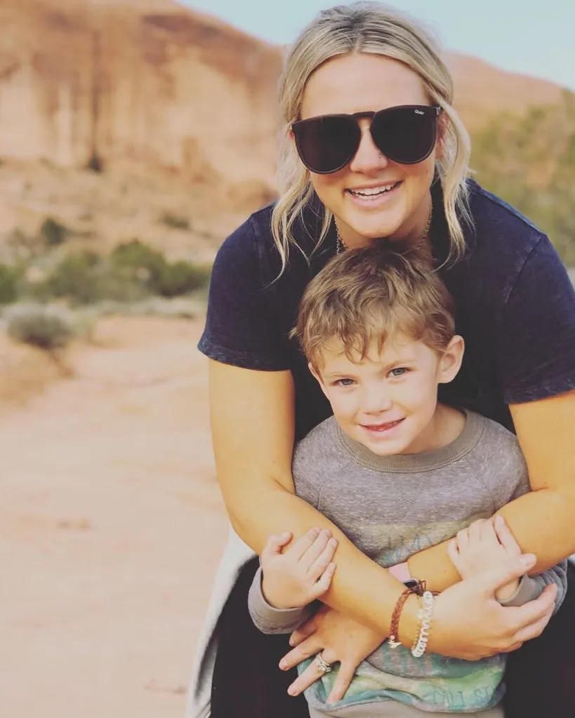 Isabella Beck hugging her son Reis Beck from behind.