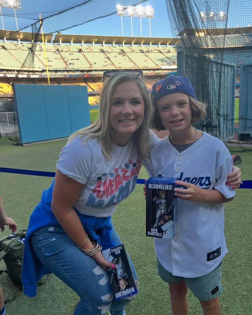Isabella Beck and Reis Beck smiling at a baseball game.