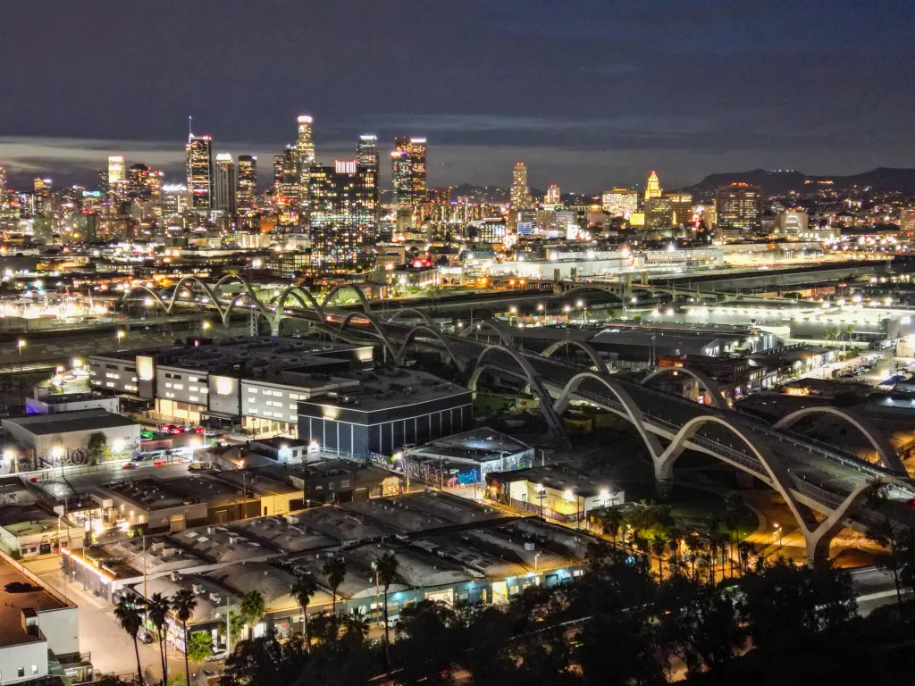 Overhead night view of Downtown Los Angeles and the Sixth Street Viaduct, which lacks illumination due to copper wire theft.