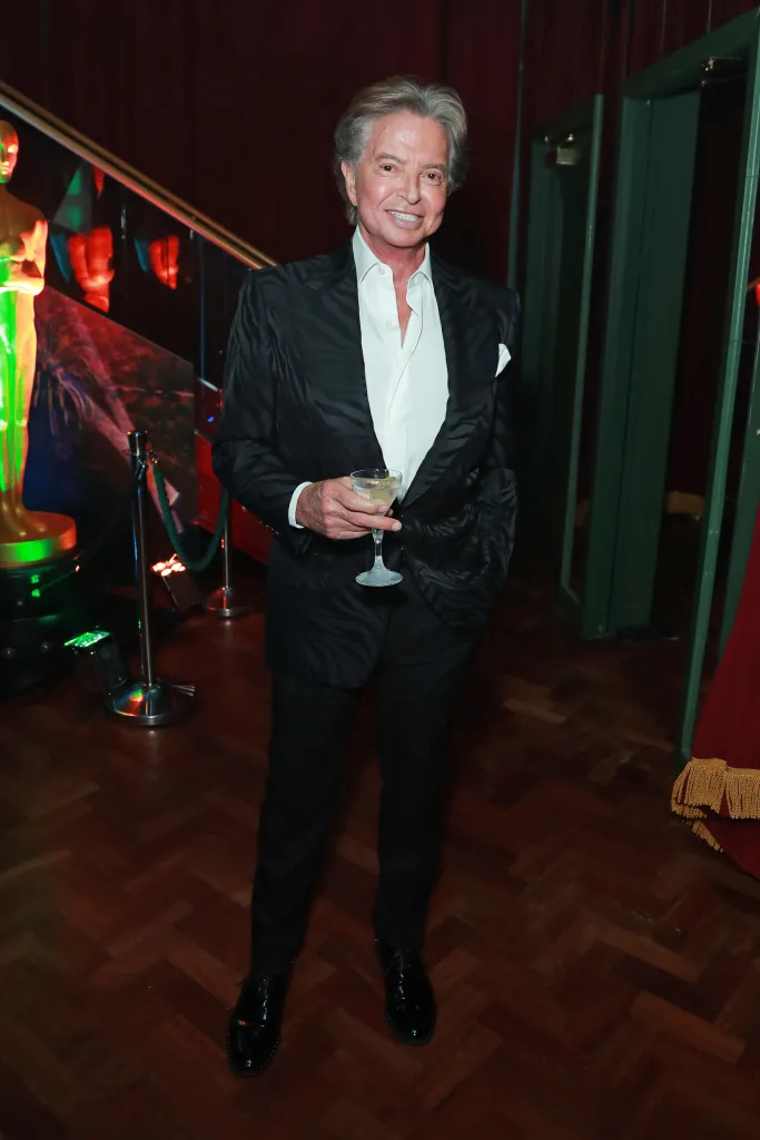 Richard Caring holding a drink at Lisa Tchenguiz's birthday party.