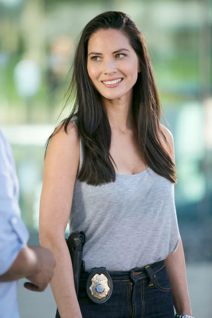 Olivia Munn as a police officer with a badge and gun in "Ride Along 2".