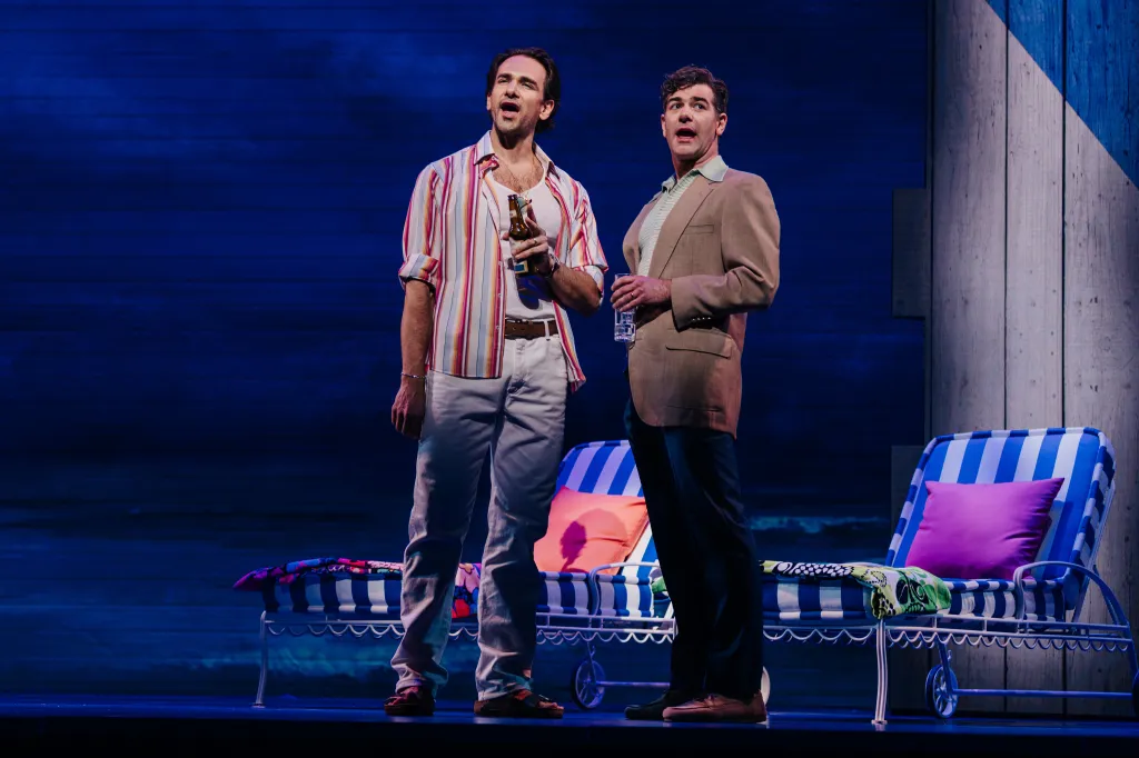 Brent Thiessen (left) and Ben Jacoby (right) stand on a stage.