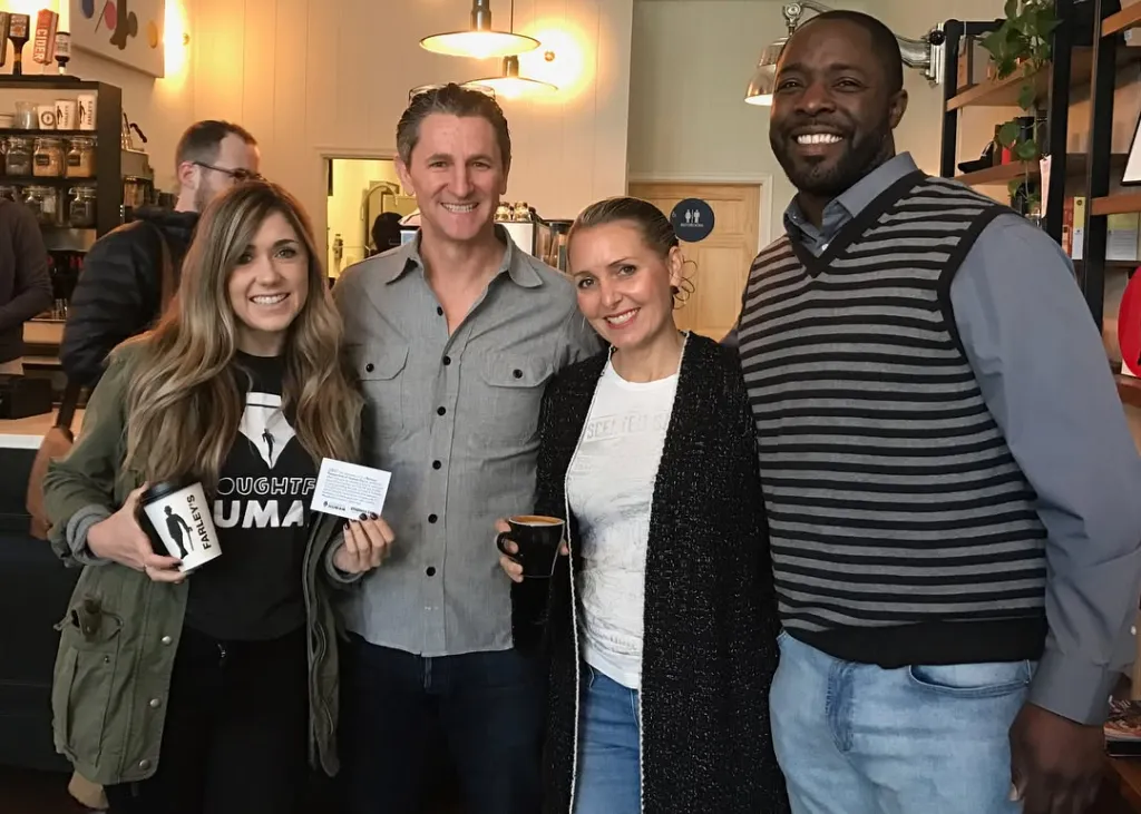 Amy Hillyard (second from right) with three other people in a cafe.