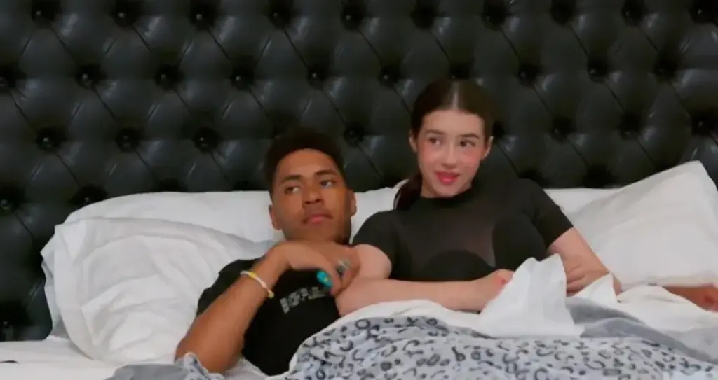Robert Cosby and Alexiana Arian Smokoff lying in bed.