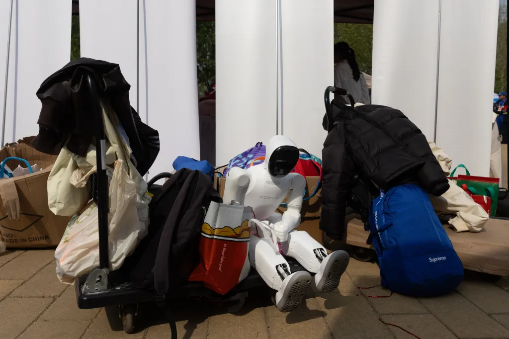 A robot sits on a cart with clothes and bags at the Beijing E-Town Half Marathon.