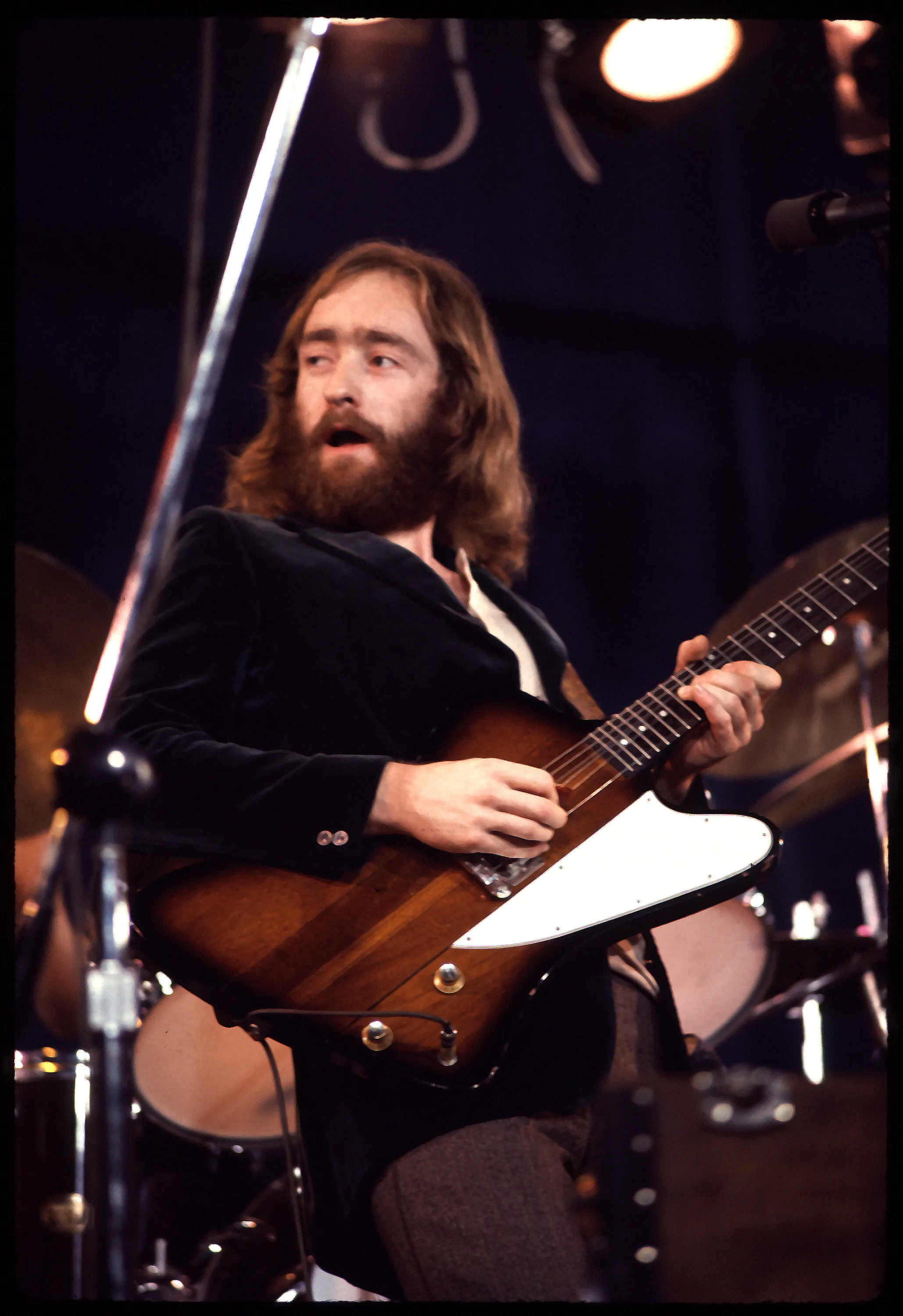 Rock musician Dave Mason performing a guitar solo.