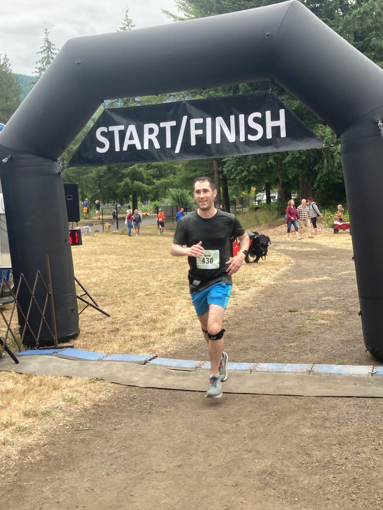 Runner Andy Solarz crosses the finish line.