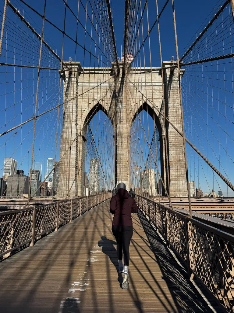 Runner Molly Baker jogging across the Brooklyn Bridge.