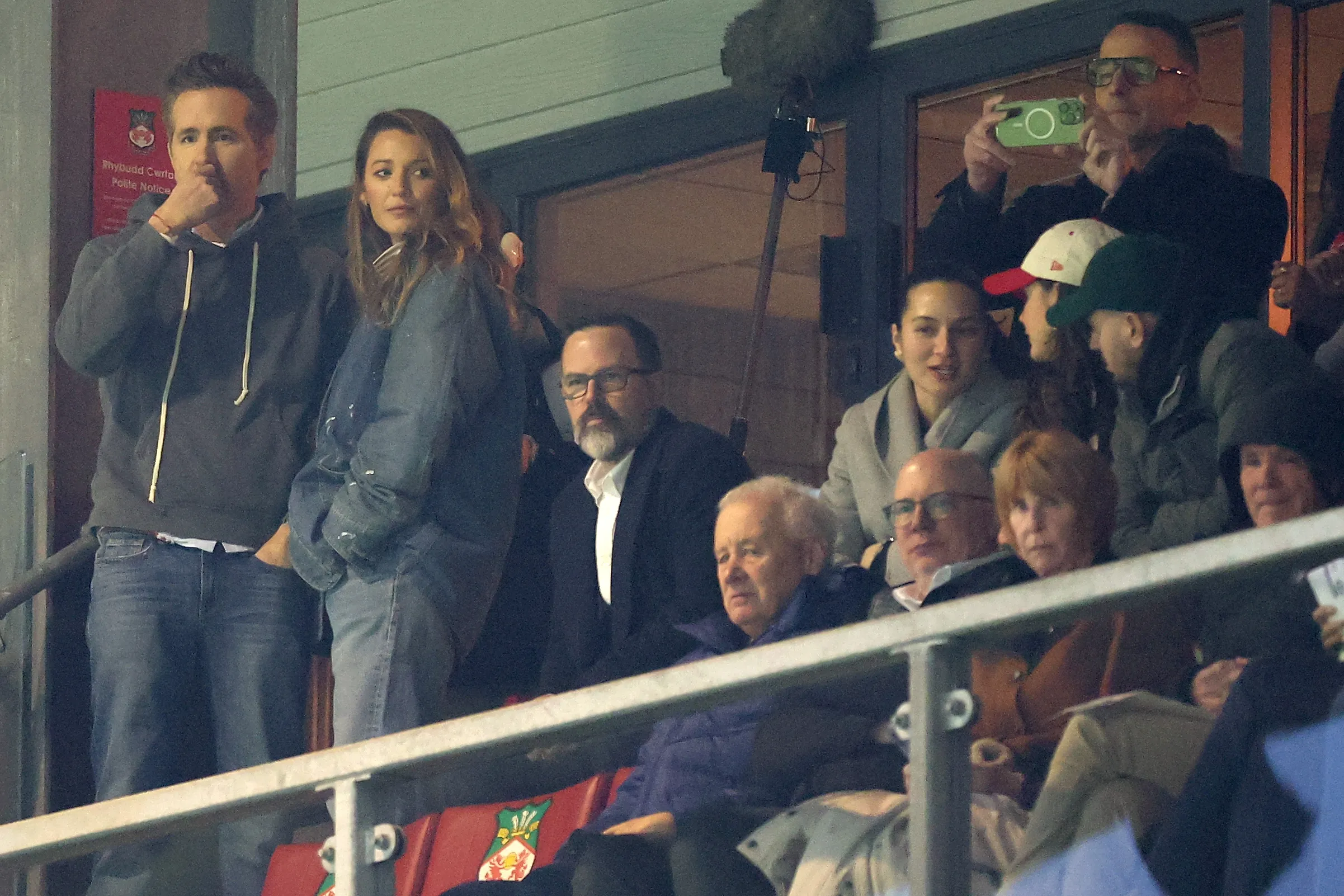 Actor Ryan Reynolds and actress Blake Lively watch a football match from the stands.
